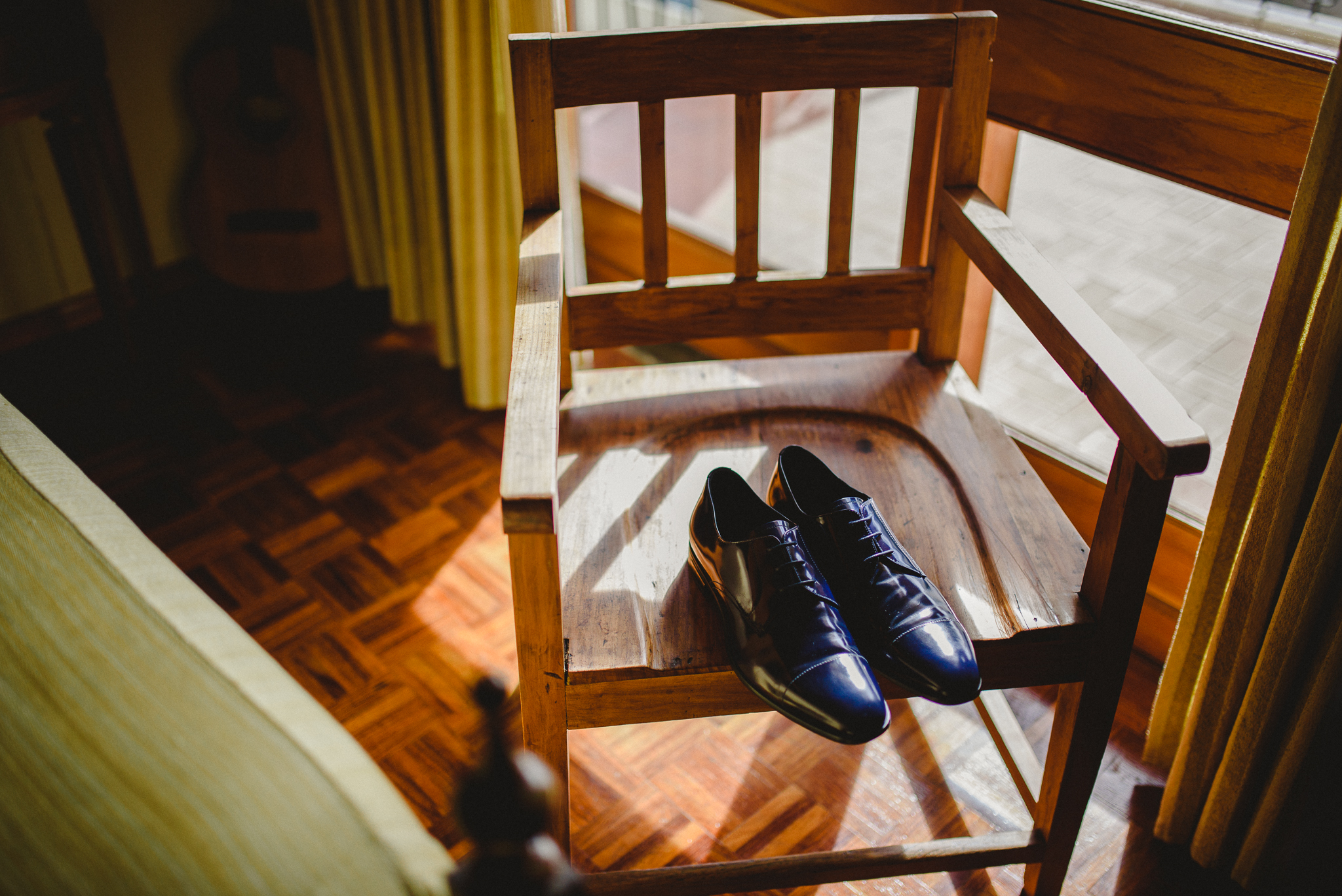 Groom's shoes on a chair while he gets ready.