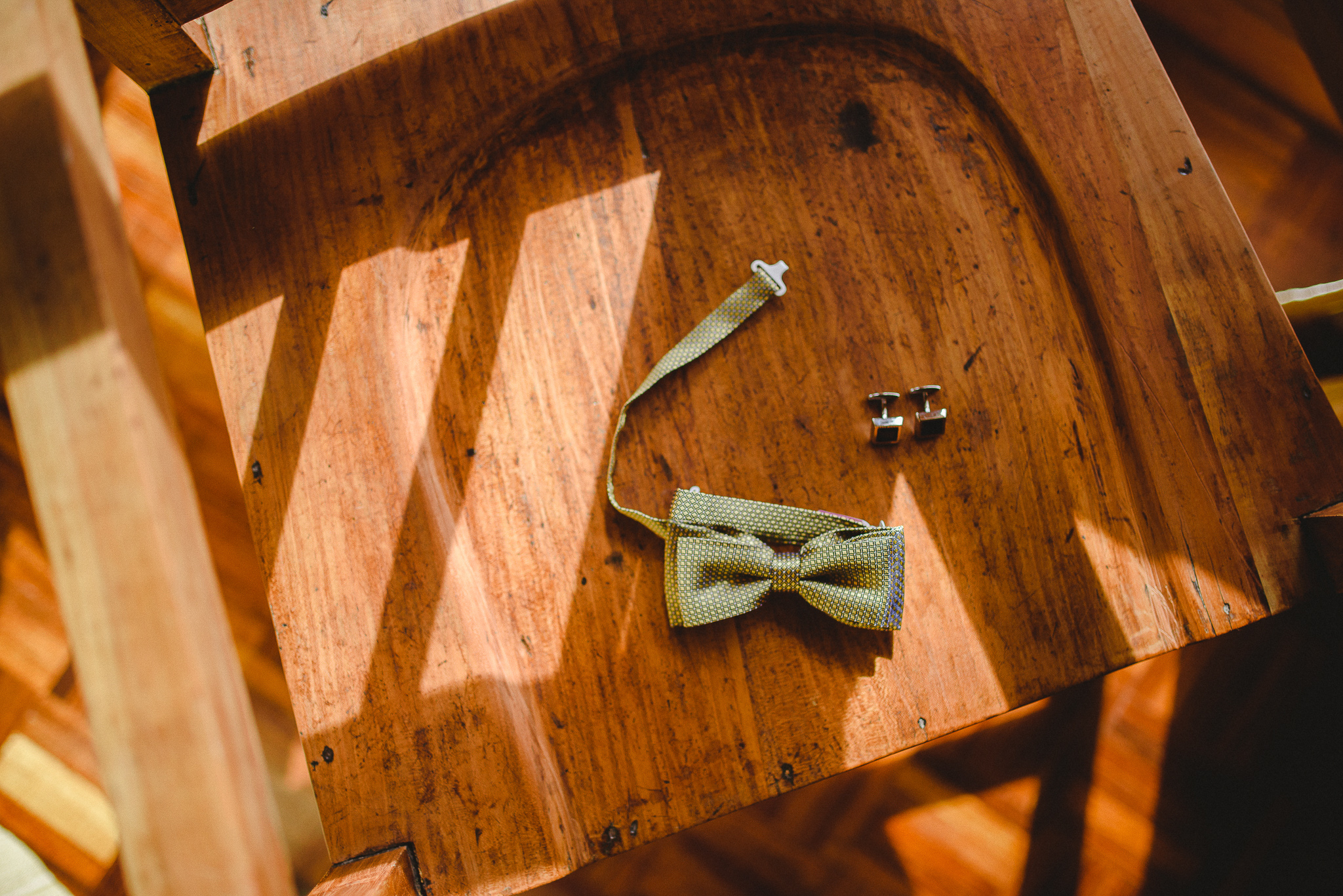 Groom's bowtie displayed on a chair while he gets ready