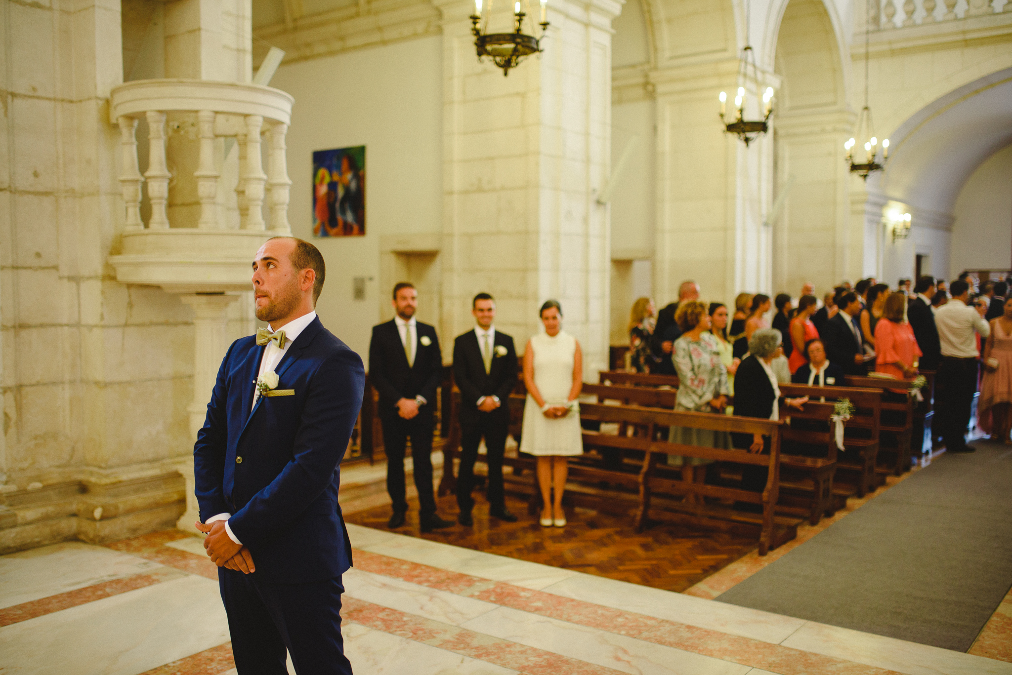 Groom waiting for bride while she walks down the aisle