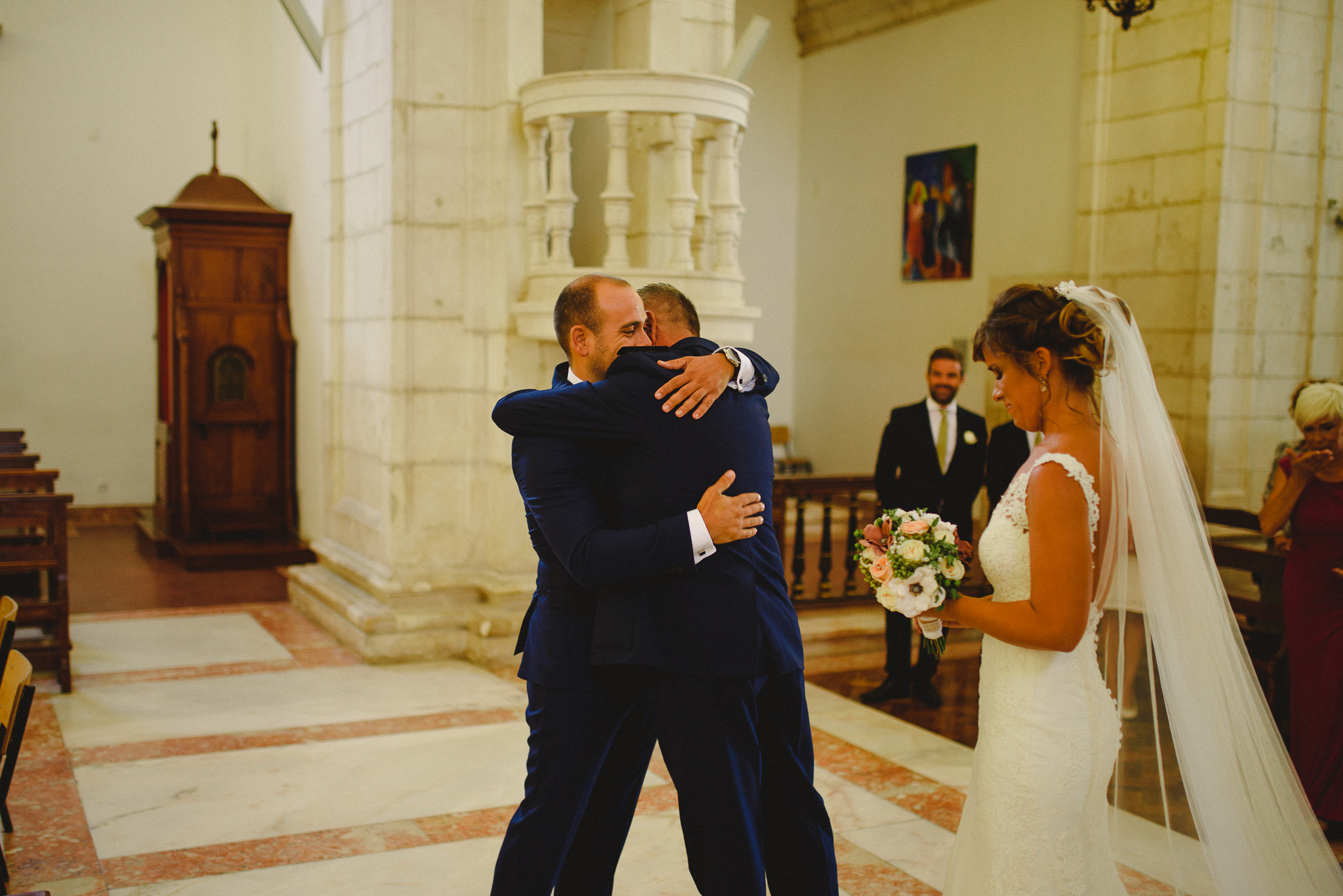 Father of the bride hugging groom after arriving with bride