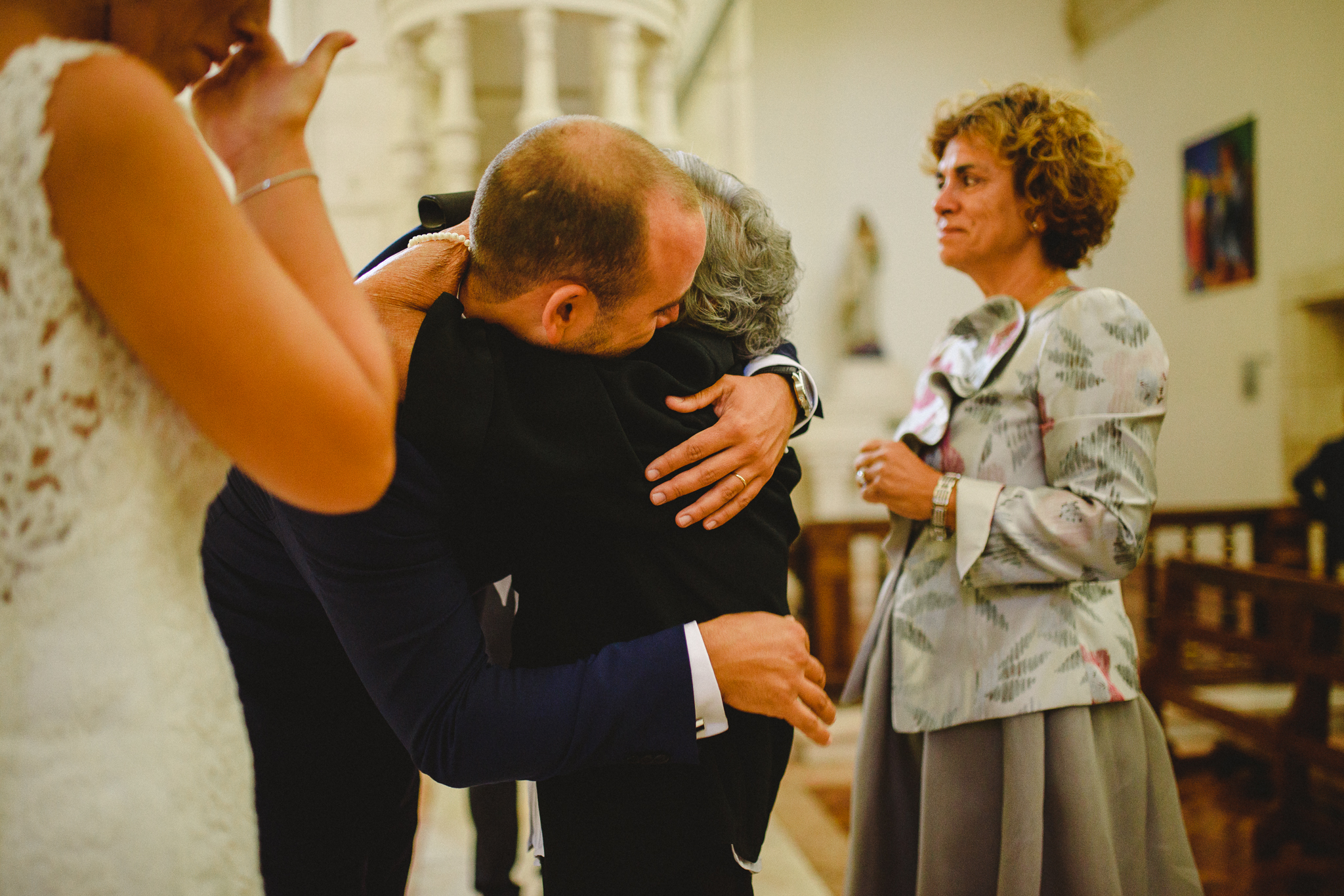 Groom hugging his grandmother during ceremony