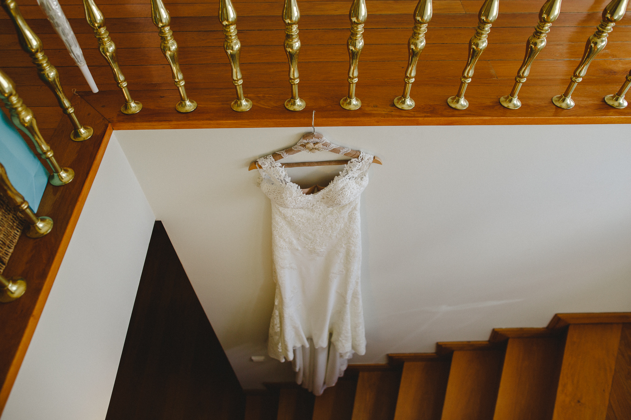 Bride's wedding dress hanging on the stairs