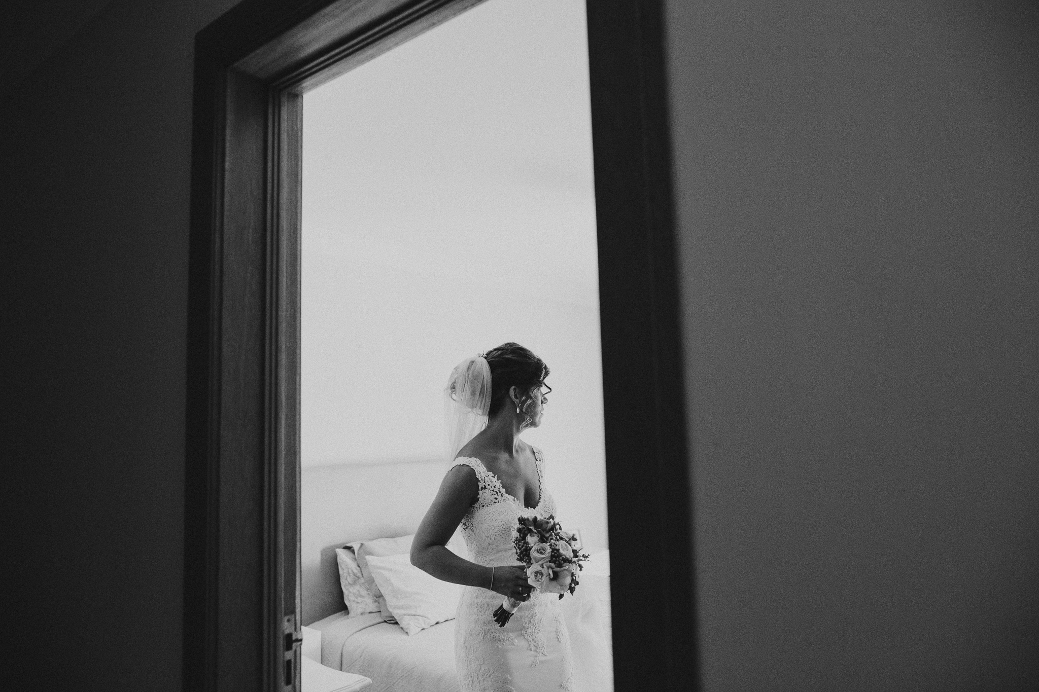 Bride holding her flowers leaving her room.