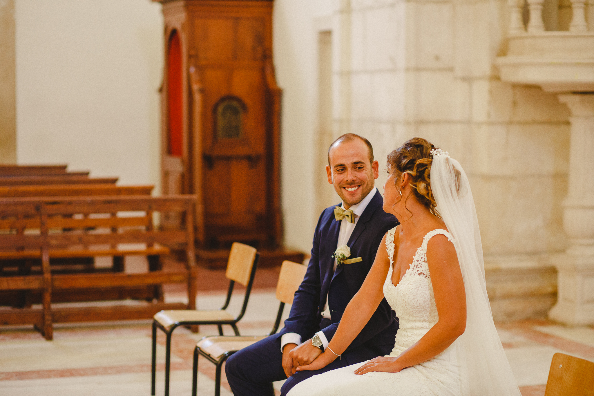 Groom smiling at bride during ceremony