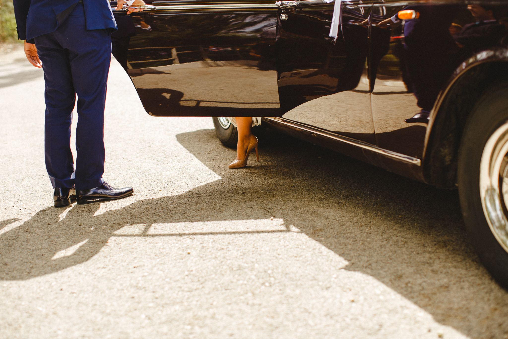 Bride coming out of her car wearing Christian Louboutin shoes