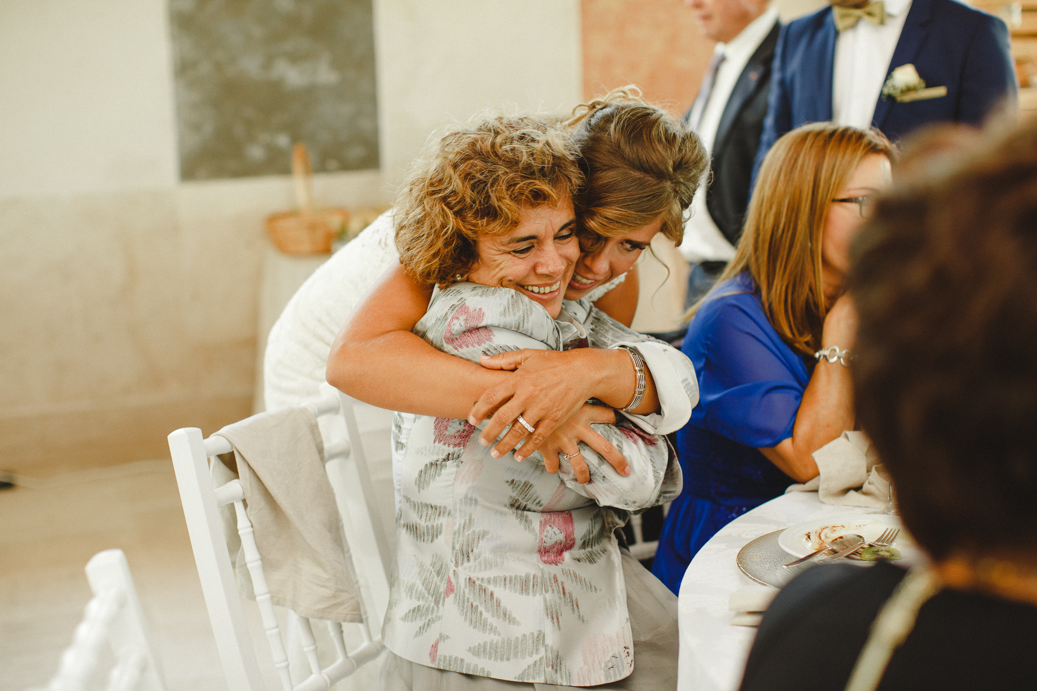 Bride hugging her mother-in-law before lunch.