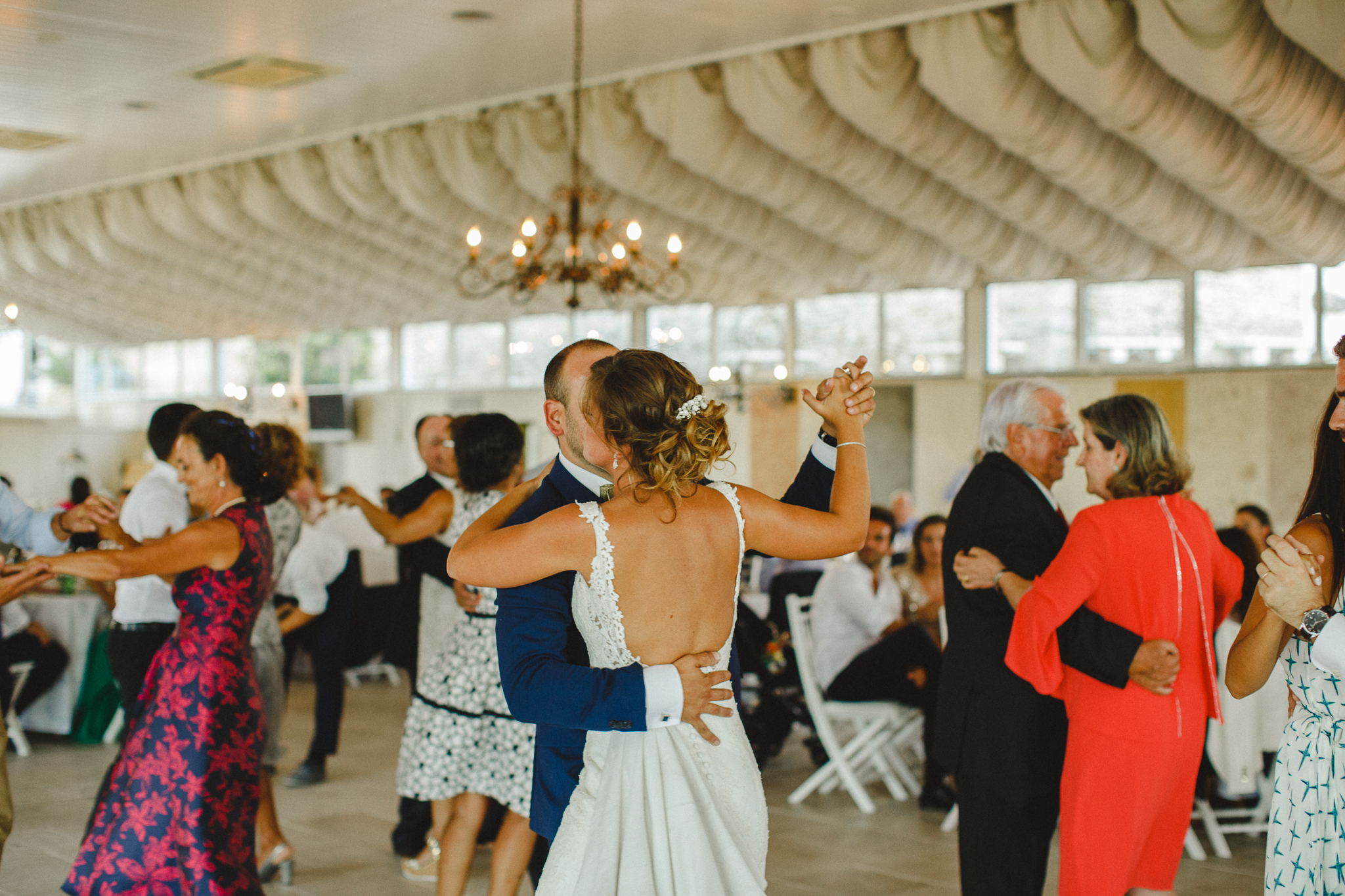 Bride and groom and guests dancing during wedding's lunch