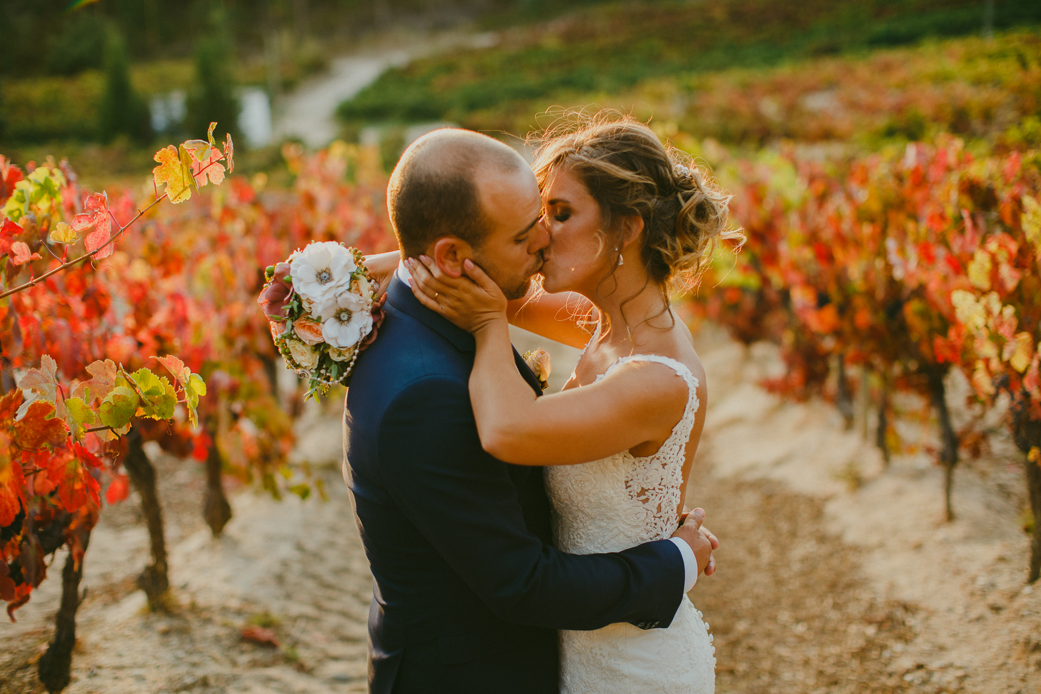 Bride and groom during their bridal photo shoot during sunset in the vineyards.