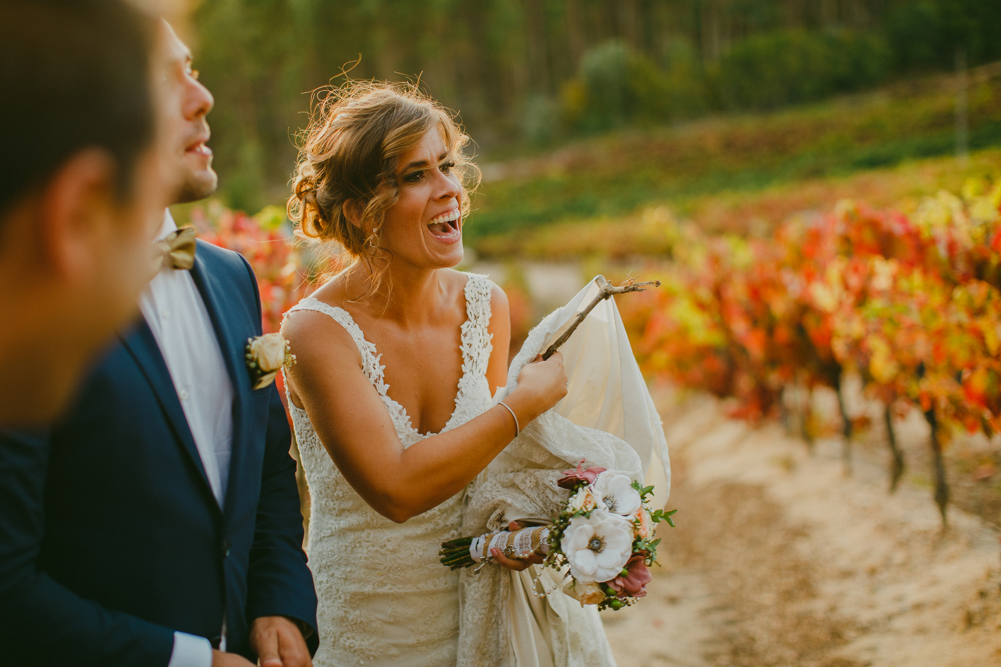 Bride taking a stick out of her wedding dress after bridal shoot.