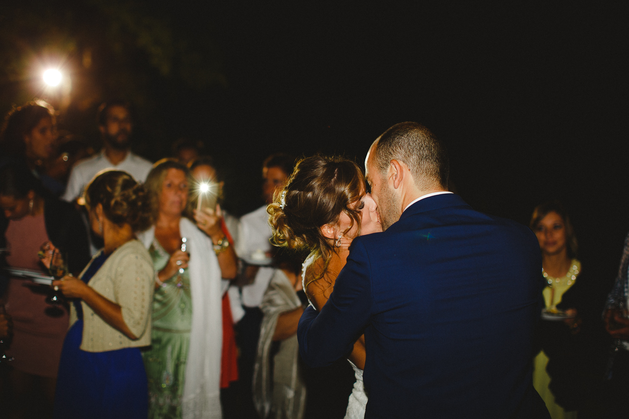 Bride and groom kissing after making a toast