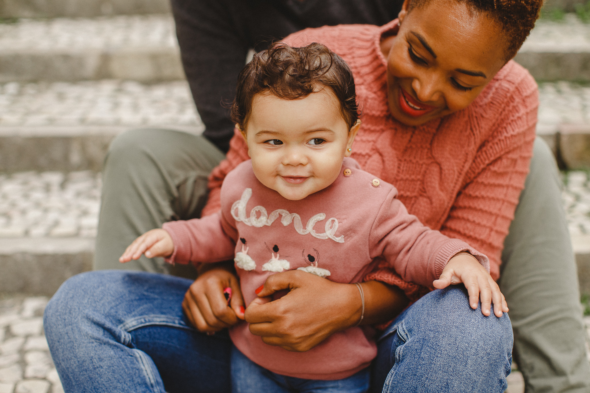 Baby smiling with parents during a family photo shoot in Lisbon. 