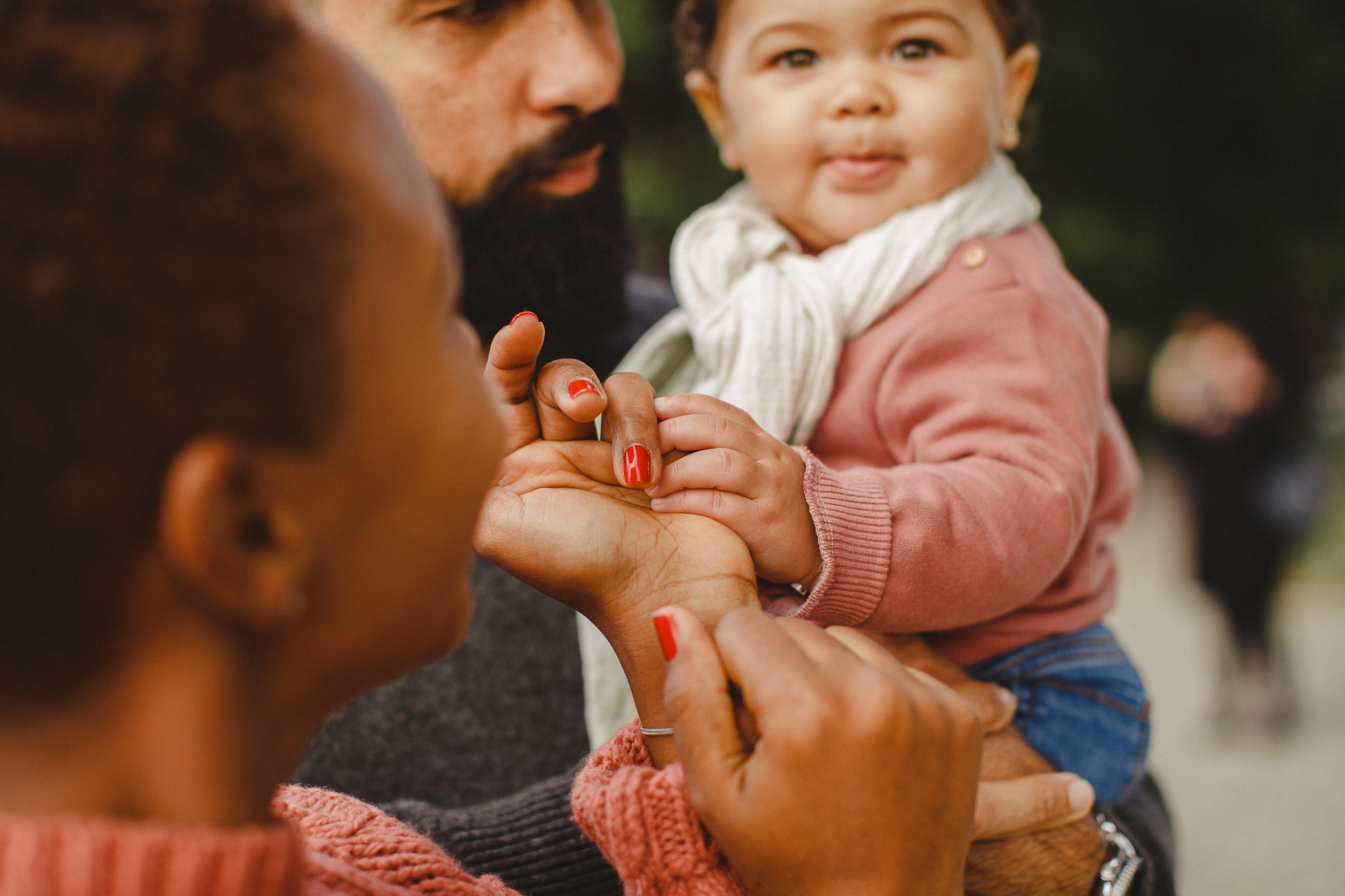 Mom holding her daughter's hand during a family photo shoot in lisbon. 