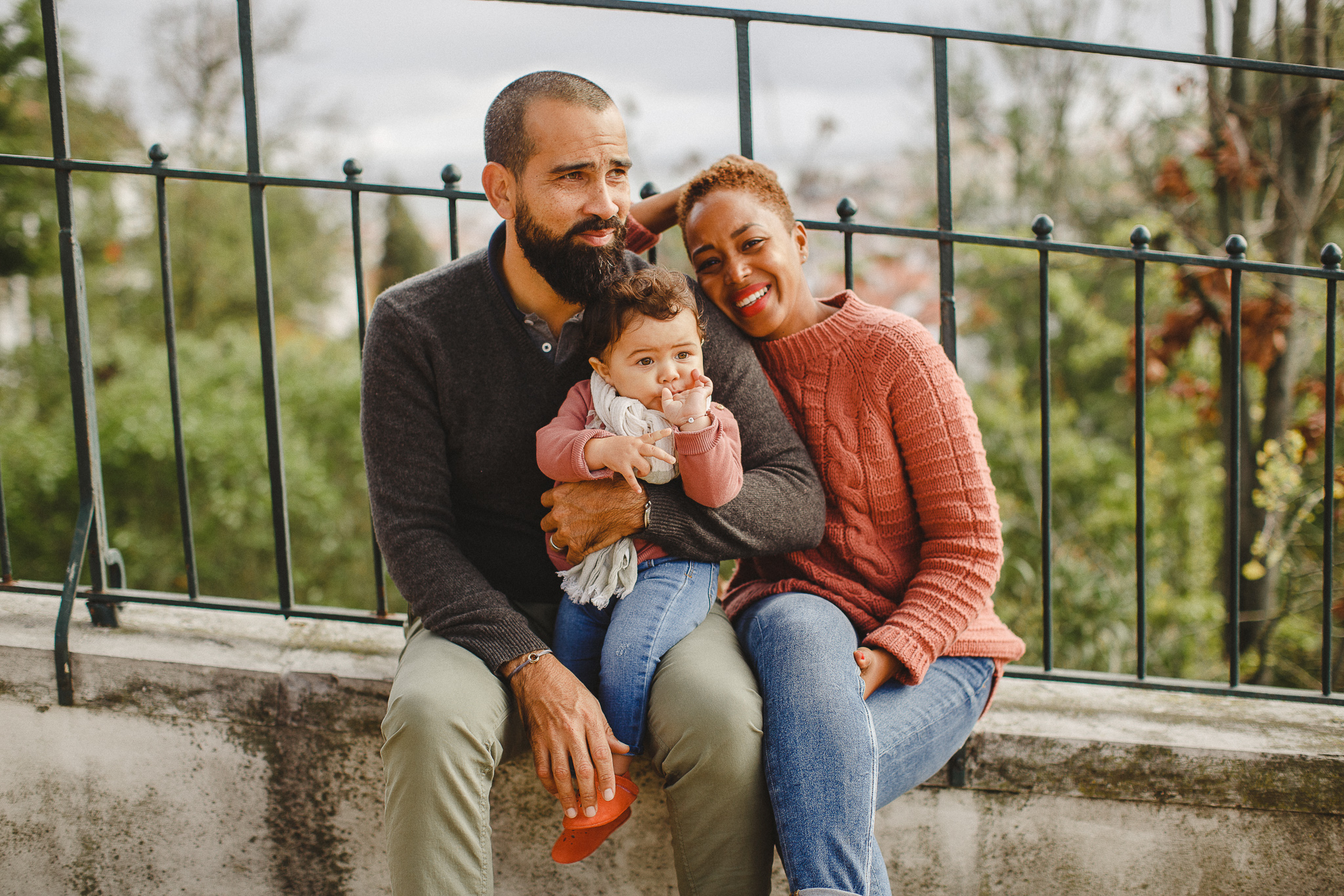 Baby on her dad's lap during a family photo shoot in Lisbon, by Hello Twiggs.