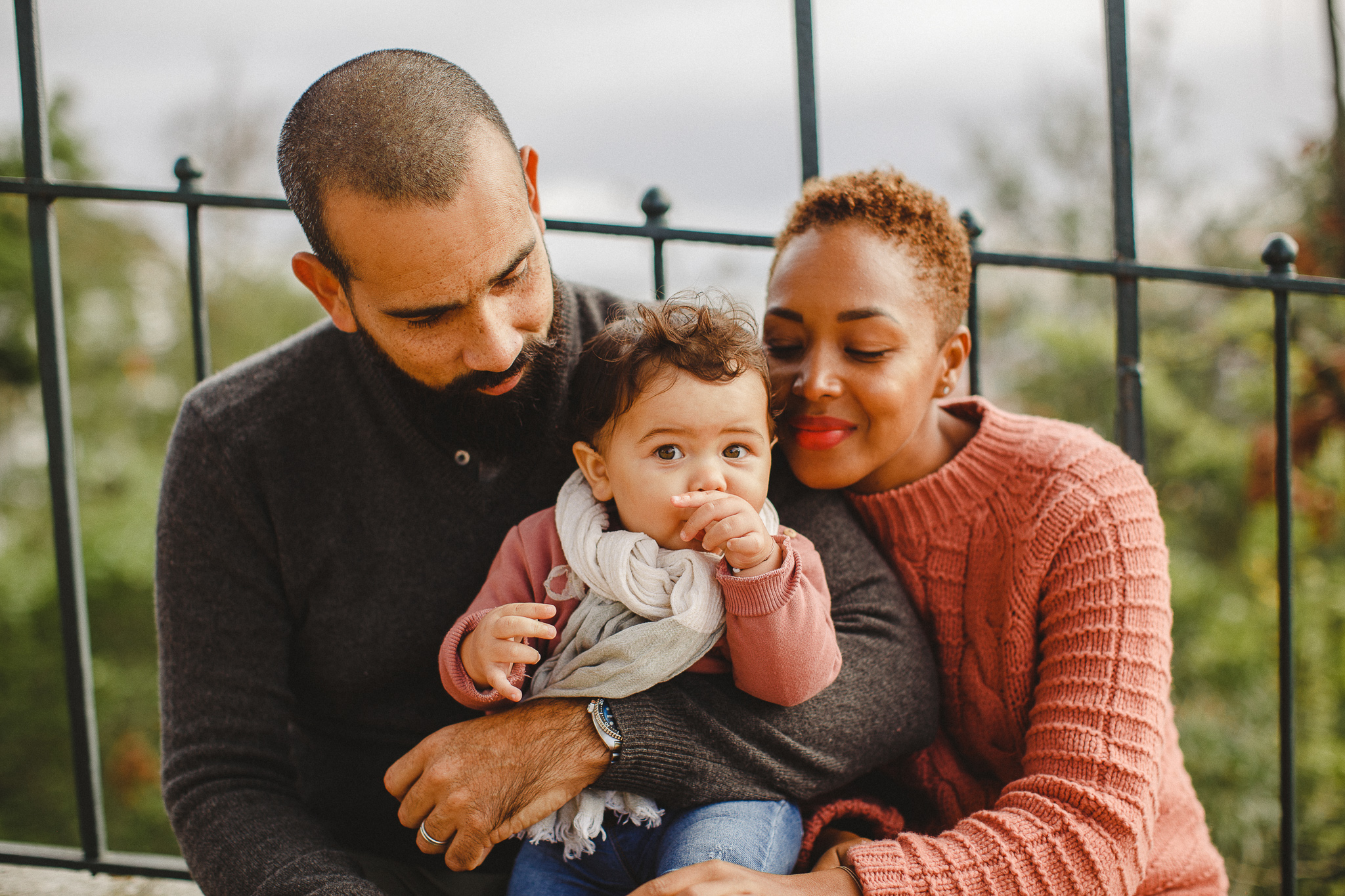 Family sitting down with their baby daughter during a family photo shoot in Lisbon, by Hello Twiggs.